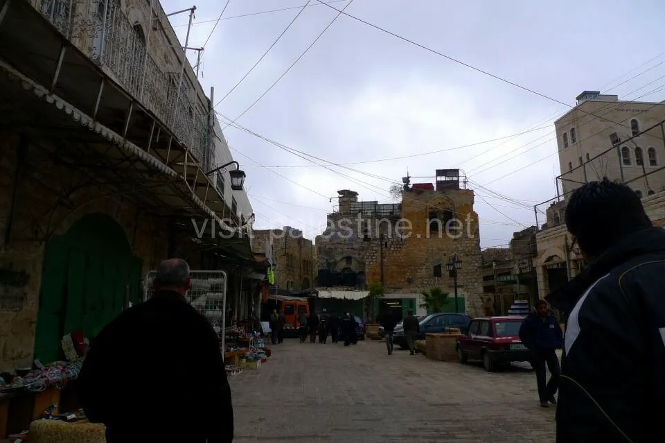 The entrance of the Old City of Hebron. High buildings suddenly disappear here. The entrance of the Old City, Hebron