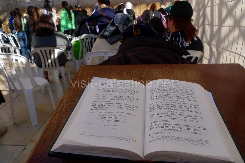 Visit quietly as many Jews are praying. Hebrew Bible at the Western Wall, Jerusalem